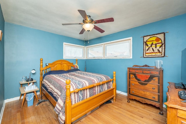 bedroom with wood finished floors, baseboards, and ceiling fan