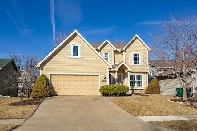 traditional-style house featuring driveway and a shingled roof