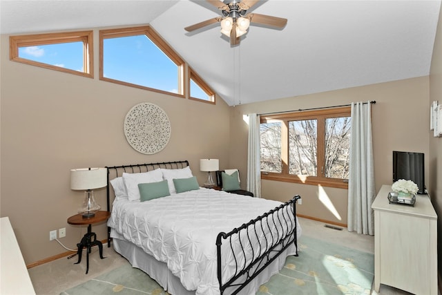 bedroom with visible vents, light colored carpet, high vaulted ceiling, and multiple windows