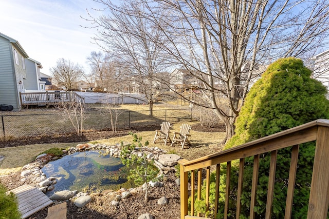 view of yard featuring a wooden deck and fence