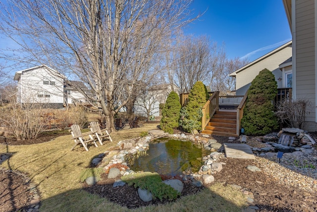 view of yard featuring a wooden deck and stairs