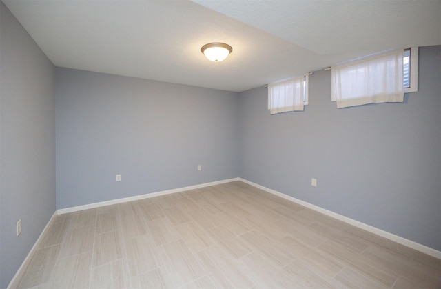 empty room featuring baseboards