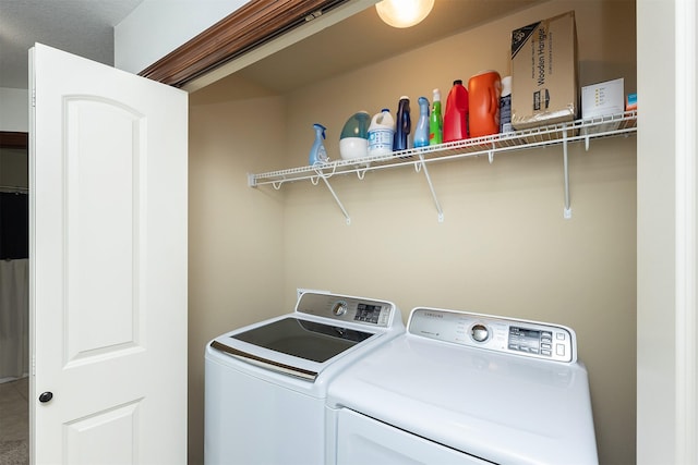 washroom featuring laundry area and washing machine and dryer