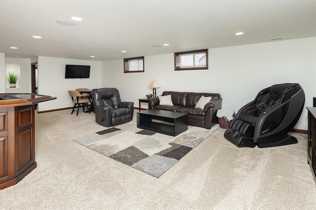 living room with recessed lighting, baseboards, and light colored carpet