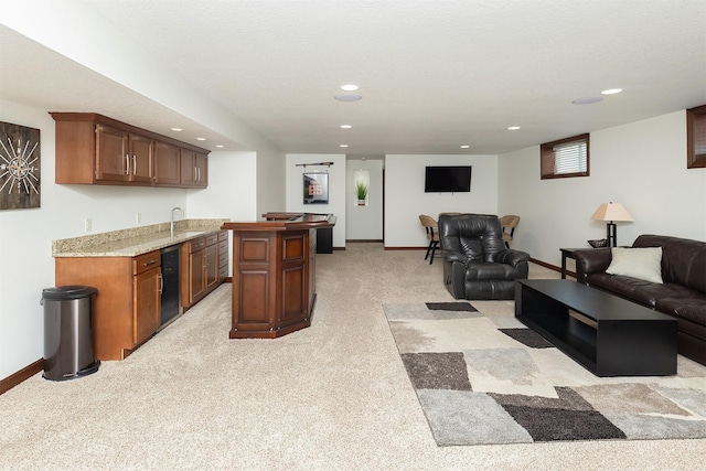 kitchen featuring light colored carpet, baseboards, open floor plan, and a kitchen island