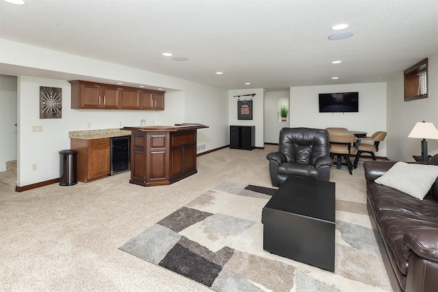 living area with recessed lighting, wine cooler, wet bar, baseboards, and light colored carpet