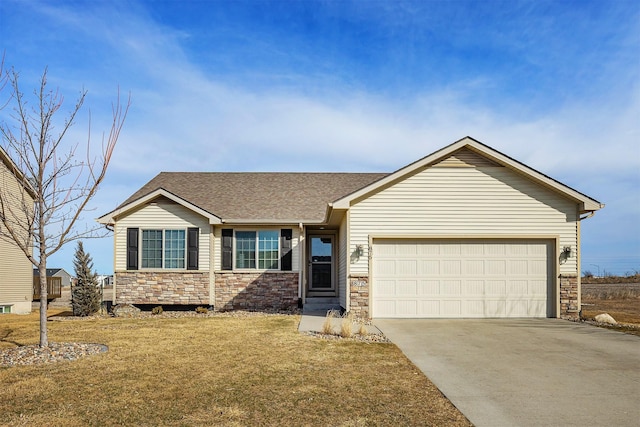 ranch-style house featuring stone siding, driveway, an attached garage, and a front yard