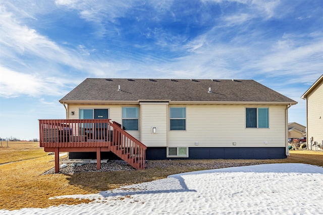 back of property with stairway, a shingled roof, and a deck