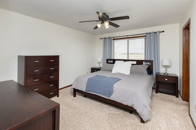 bedroom featuring baseboards, light carpet, and a ceiling fan