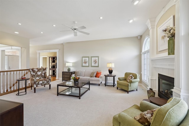 carpeted living room with recessed lighting, a fireplace, baseboards, and ceiling fan