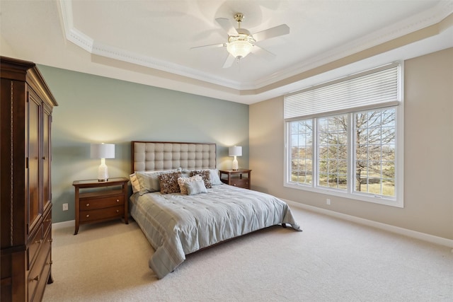 bedroom featuring baseboards, a raised ceiling, light carpet, and ornamental molding