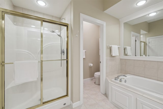 bathroom with tile patterned floors, toilet, a stall shower, recessed lighting, and a bath