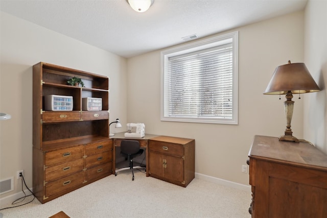 office area featuring baseboards, light carpet, and visible vents