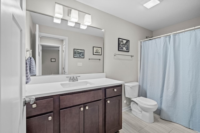 bathroom with a shower with curtain, toilet, and vanity