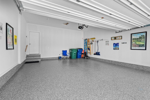 garage with a garage door opener and baseboards