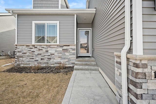 view of exterior entry featuring stone siding