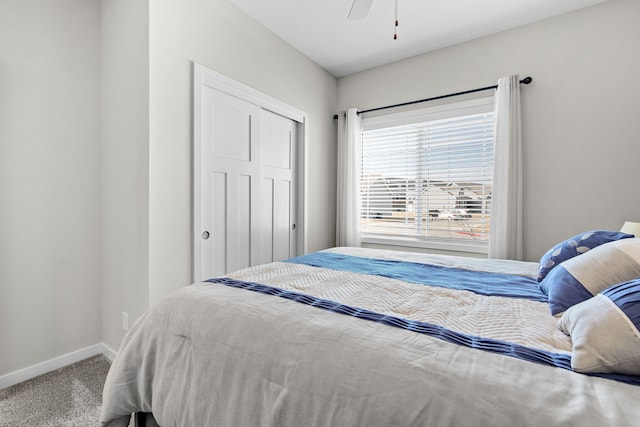 carpeted bedroom featuring a closet, a ceiling fan, and baseboards