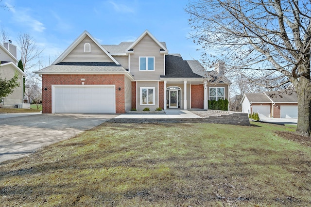 view of front of house with brick siding, a shingled roof, a front lawn, concrete driveway, and a garage