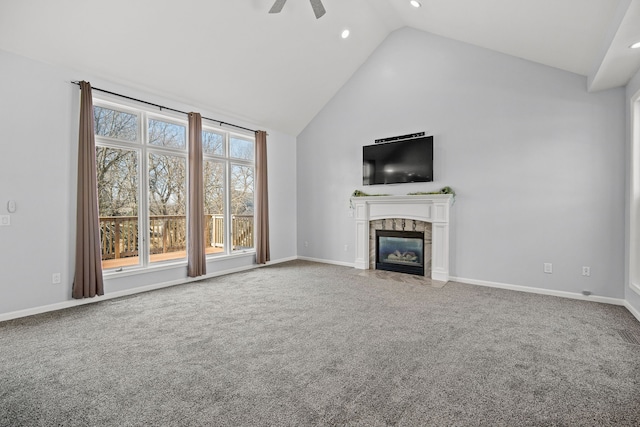 unfurnished living room with a ceiling fan, baseboards, carpet floors, high vaulted ceiling, and a tile fireplace