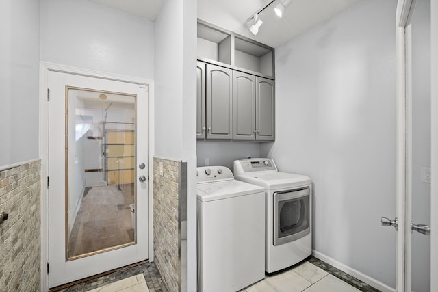 laundry room featuring cabinet space, independent washer and dryer, and track lighting