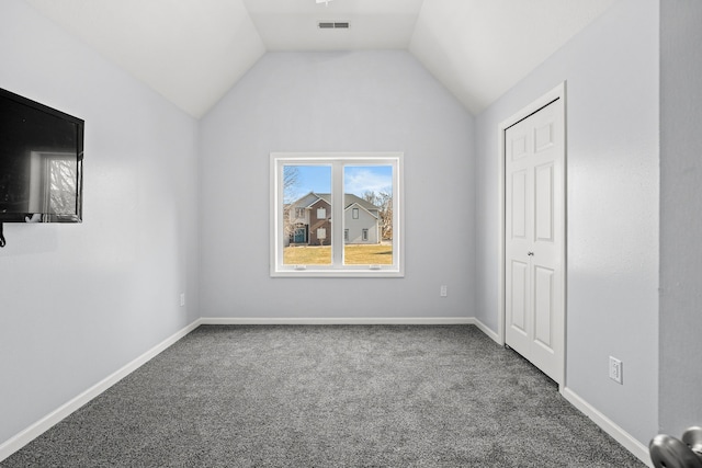 unfurnished bedroom with visible vents, baseboards, carpet, and lofted ceiling