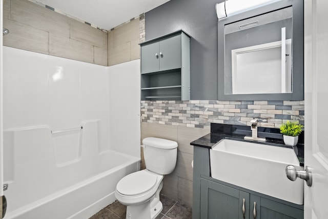 bathroom featuring tile patterned floors, visible vents, toilet, tile walls, and vanity