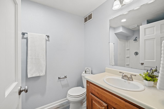 full bathroom featuring vanity, toilet, baseboards, and visible vents