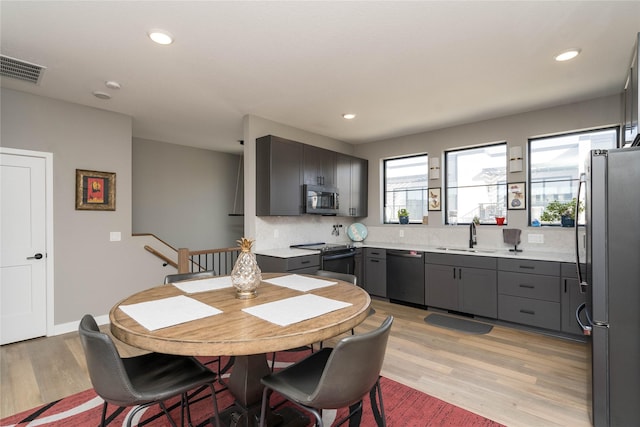 dining room with recessed lighting, visible vents, light wood-type flooring, and baseboards