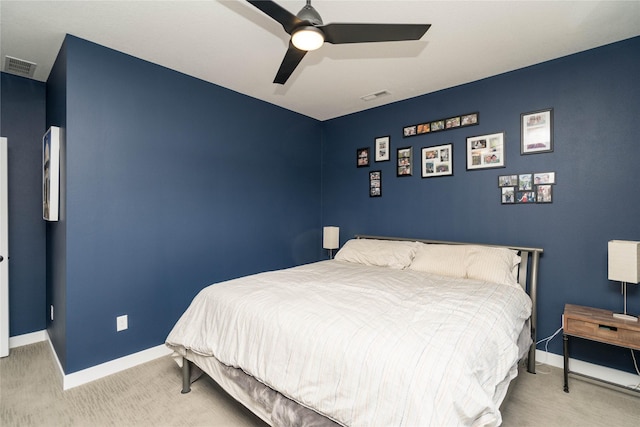 bedroom with visible vents, light carpet, and baseboards