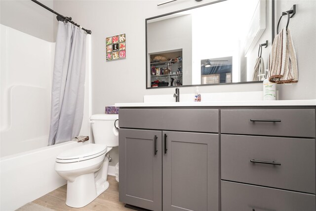 1343 Keosauqua Way, Des Moines, IA 50309 - full bath featuring toilet, vanity, wood finished floors, and shower / bath combination with curtain