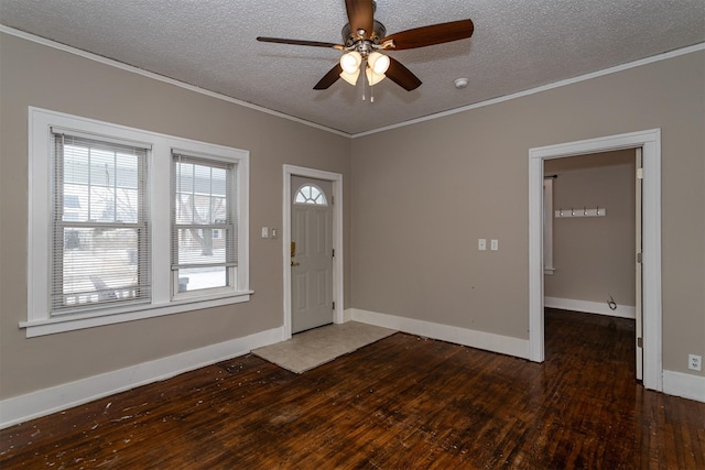 entrance foyer featuring a ceiling fan, hardwood / wood-style flooring, a textured ceiling, crown molding, and baseboards