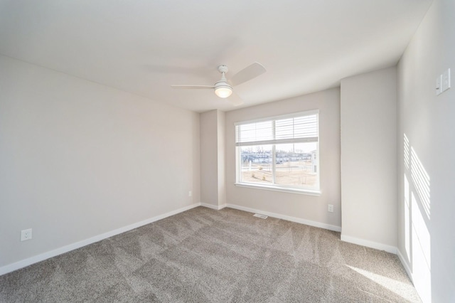 empty room with a ceiling fan, carpet, and baseboards