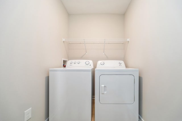 clothes washing area with laundry area and separate washer and dryer