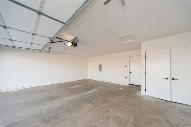 garage with electric panel and a garage door opener