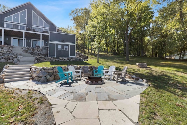 view of patio / terrace with stairway and an outdoor fire pit