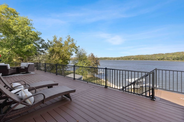 wooden terrace featuring an outdoor hangout area and a water view