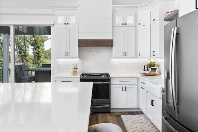 kitchen featuring decorative backsplash, dark wood-type flooring, white cabinets, and appliances with stainless steel finishes