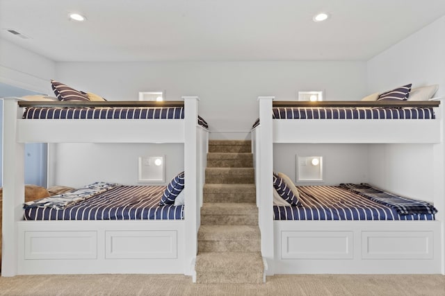 carpeted bedroom with recessed lighting and visible vents