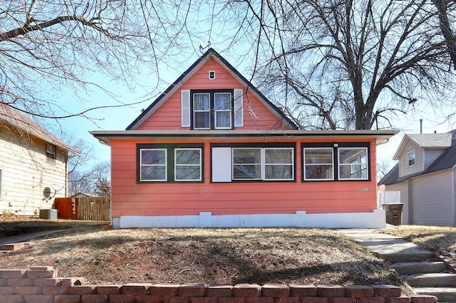 view of front of house featuring central AC and fence