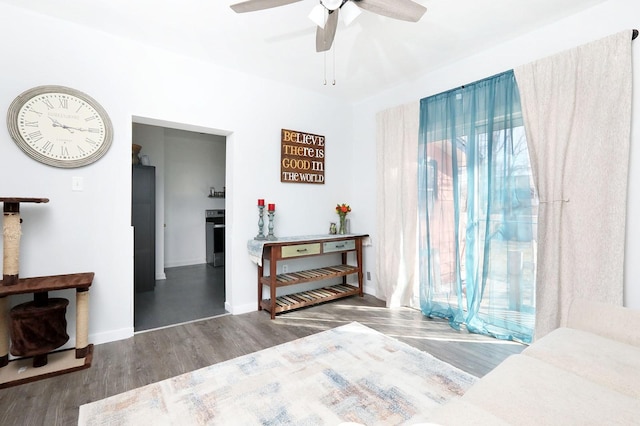 bedroom with multiple windows, wood finished floors, baseboards, and ceiling fan