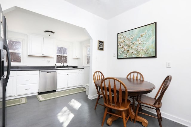 dining area featuring arched walkways and baseboards