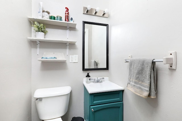 half bath featuring vanity and toilet