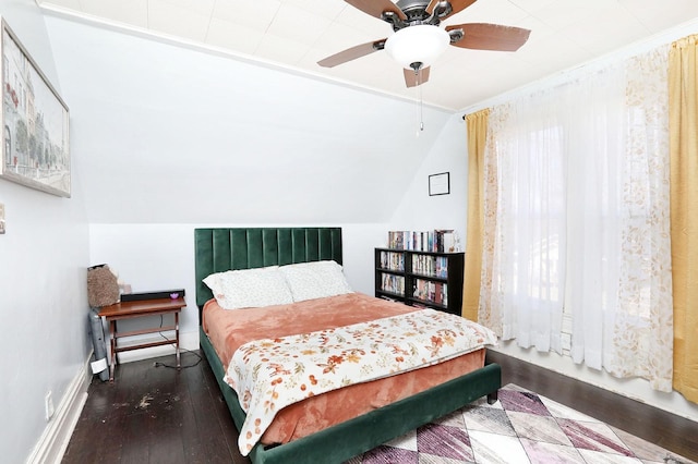 bedroom with ceiling fan, multiple windows, lofted ceiling, and wood finished floors