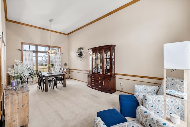 carpeted living area featuring crown molding, a notable chandelier, baseboards, and a towering ceiling