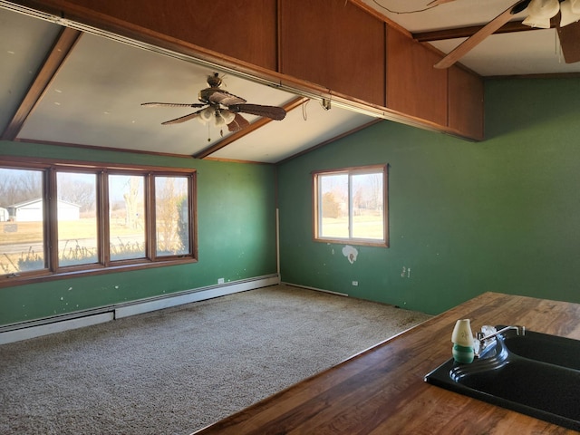 spare room with lofted ceiling, ceiling fan, a sink, carpet flooring, and baseboard heating