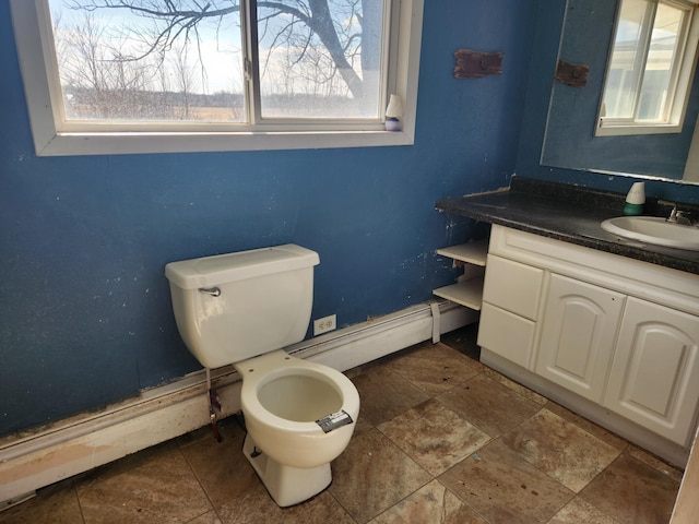 bathroom featuring toilet, vanity, and a baseboard radiator