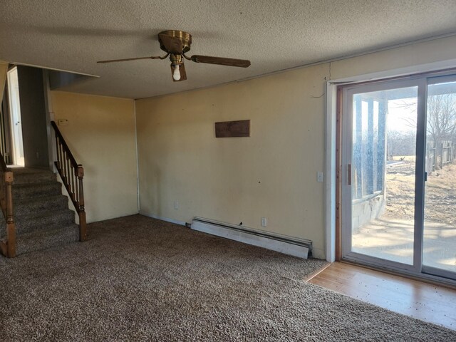 unfurnished bedroom featuring a closet, baseboard heating, a ceiling fan, and carpet floors