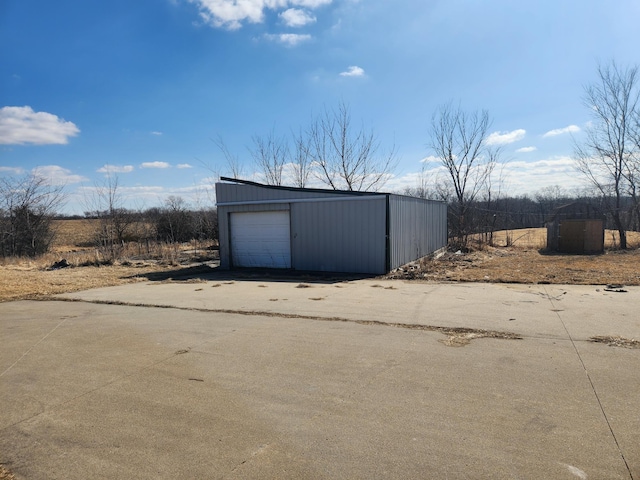 detached garage featuring driveway