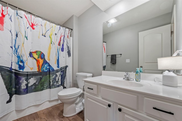 bathroom featuring vanity, toilet, wood finished floors, and shower / bath combo with shower curtain