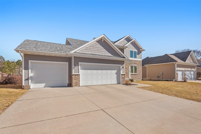 craftsman-style home with a front lawn, a garage, and driveway